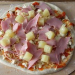 Pizza Hawaii (roh) Pizza Hawaii mit Schinken und Ananas, roh, vor dem Backen